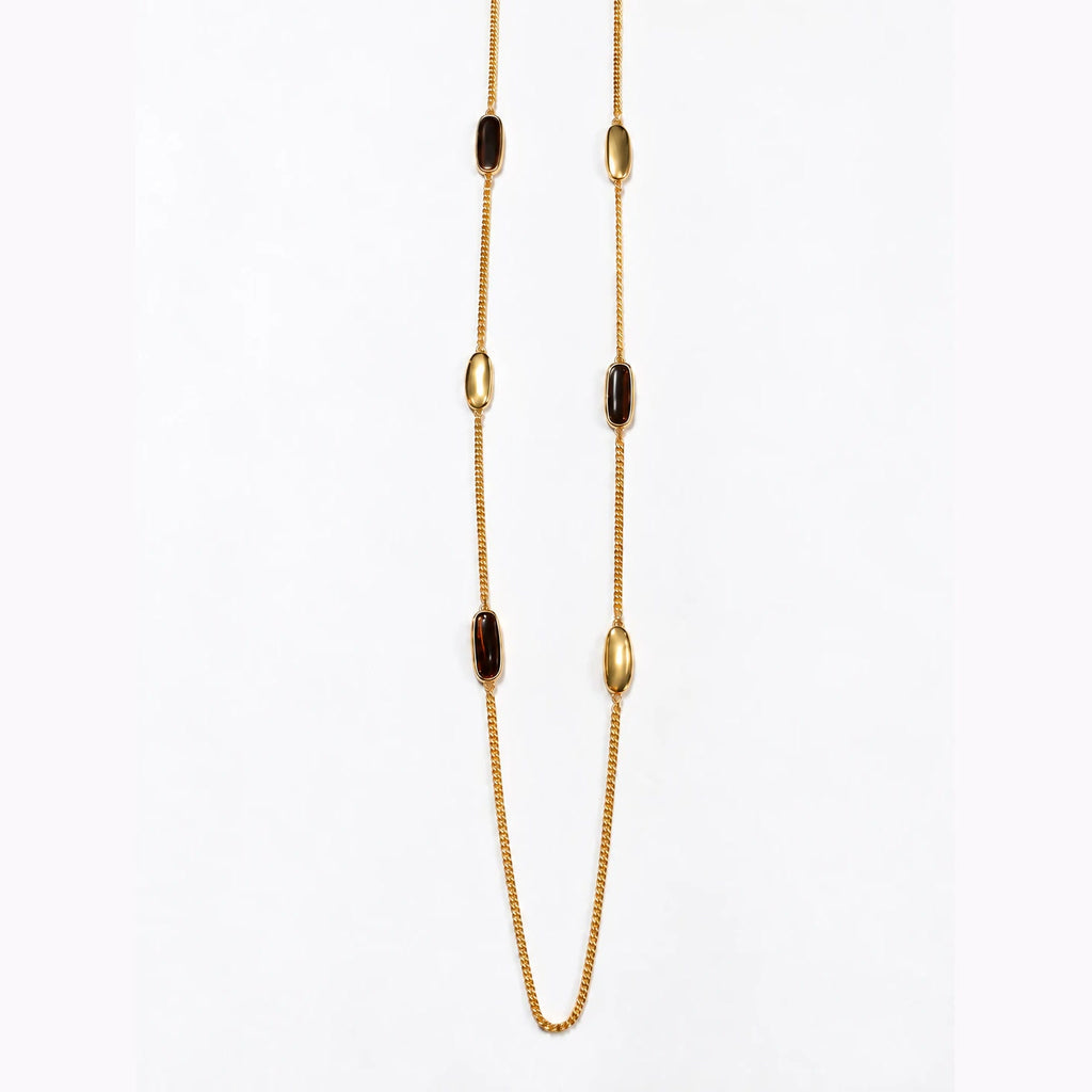 Sautoir Liora Bertalia, cabochons d'émail marron foncé sertis d'or sur une chaîne longue dorée